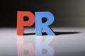 Multicolored word PR made of wood.