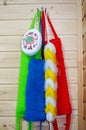 Multicolores washcloths hanging on metal hooks in a rustic bathroom Royalty Free Stock Photo