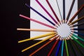 Multicolour pencils and sheet of paper on black background. Art and creativity concept. Royalty Free Stock Photo