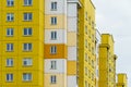 Multicoloured high-rise residential buildings in affluent areas. Multi-apartment multi-storey building with a multicolored facade Royalty Free Stock Photo