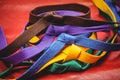 Multicoloured karate belts on red background Royalty Free Stock Photo