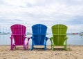 Multicoloured Muskoka Cottage Beach chairs on the sand looking out to the harbor Royalty Free Stock Photo