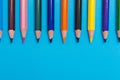 Multicoloured pencils on blue background, back to scool concept