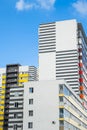 Multicoloured residential high-rise building against blue sky. Urban real estate background Royalty Free Stock Photo