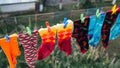 Multicoloured socks are dried on a string