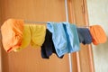 Multicoloured socks drying at home