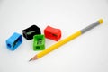 The multicolours four sharpner with yellow colour wooden pencil  isolated in white background Royalty Free Stock Photo