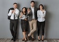 multicultural business people in formal wear showing ok sign while standing