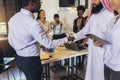 Multicultural business people meeting and talking about business. Arab businessman shaking hands with his partner Royalty Free Stock Photo