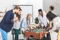 multicultural businessmen and businesswomen playing table football together Royalty Free Stock Photo