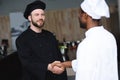 multicultural chefs shaking hands