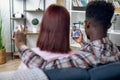 Multicultural couple using mobile for video call with family Royalty Free Stock Photo