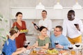 Multiethnic women and men friends chatting and drinking Royalty Free Stock Photo