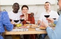 Multiethnic women and men friends chatting and drinking Royalty Free Stock Photo