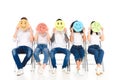 multicultural friends in blue jeans sitting on chairs isolated Royalty Free Stock Photo