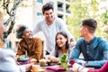 Multicultural friends drinking cappuccino at coffee bar restaurant - Young people having fun together Royalty Free Stock Photo