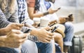 Multicultural friends group using smartphone with coffee cup