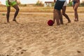 Multicultural friends playing soccer together on the sandy beach Royalty Free Stock Photo