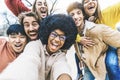 Multicultural friends taking selfie picture outside - Group of young people laughing at camera together Royalty Free Stock Photo