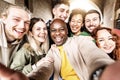 Multicultural friends taking selfie picture outside - Happy young people having fun hanging out on city street - Friendship Royalty Free Stock Photo