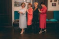 Multicultural Group of Female Friends Smiling and Interacting Indoors. A diverse group of friends smiling