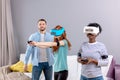 Multicultural group of friends playing games using virtual reality glasses. Royalty Free Stock Photo