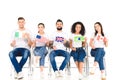 multicultural group of people sitting on chairs with flags of different countries isolated