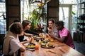 A multicultural group of students in a cafe, eating asian food, Royalty Free Stock Photo