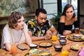 A multicultural group of young people in a cafe, eating asian fo Royalty Free Stock Photo