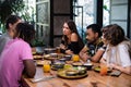 A multicultural group of young people in a cafe, eating asian fo Royalty Free Stock Photo