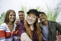 Multicultural guys and girls taking selfie outdoors - Happy friendship concept on young multiethnic people having fun day together Royalty Free Stock Photo