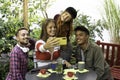 Multicultural happy friends having fun taking group selfie portrait outside in the garden during a coffee break - Mixed race young Royalty Free Stock Photo