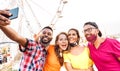 Multicultural happy travelers taking selfie wearing open face masks - New normal travel life style concept Royalty Free Stock Photo