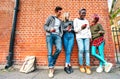 Multicultural hipster friends sharing content on smartphone at urban area in Shoreditch London Royalty Free Stock Photo