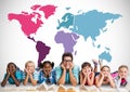 Multicultural kids reading in front of colorful world map with teacher Royalty Free Stock Photo