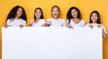 Multicultural Ladies Holding Empty Paper Board Over Yellow Background, Mockup