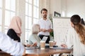 Multicultural members listens confident speaker at group meeting in boardroom Royalty Free Stock Photo