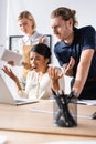 Multicultural office workers gesturing while looking