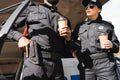 Multicultural police officers with hands on