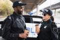 Multicultural police officers with paper cups