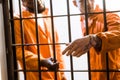 multicultural prisoners standing near prison bars Royalty Free Stock Photo