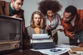 multicultural retro styled friends working in newsroom