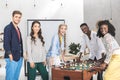 multicultural smiling business people looking at camera while playing table football Royalty Free Stock Photo