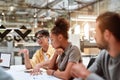 Multicultural team. Group of young business people discussing something with his young colleagues while working together Royalty Free Stock Photo