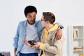 multicultural teen boys hugging and fixing computer circuit