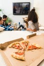 multicultural teens playing video game with pizza