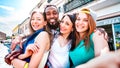 Multicultural tourists group taking selfie at old town tour - Happy millenial life style concept with young people having fun