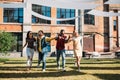 multicultural young friends holding hands while having fun together