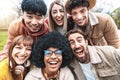 Multicultural young people smiling at camera - Happy group of multiracial students having fun in college campus Royalty Free Stock Photo