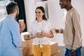 multiethnic business colleagues holding paper cups and talking while moving Royalty Free Stock Photo